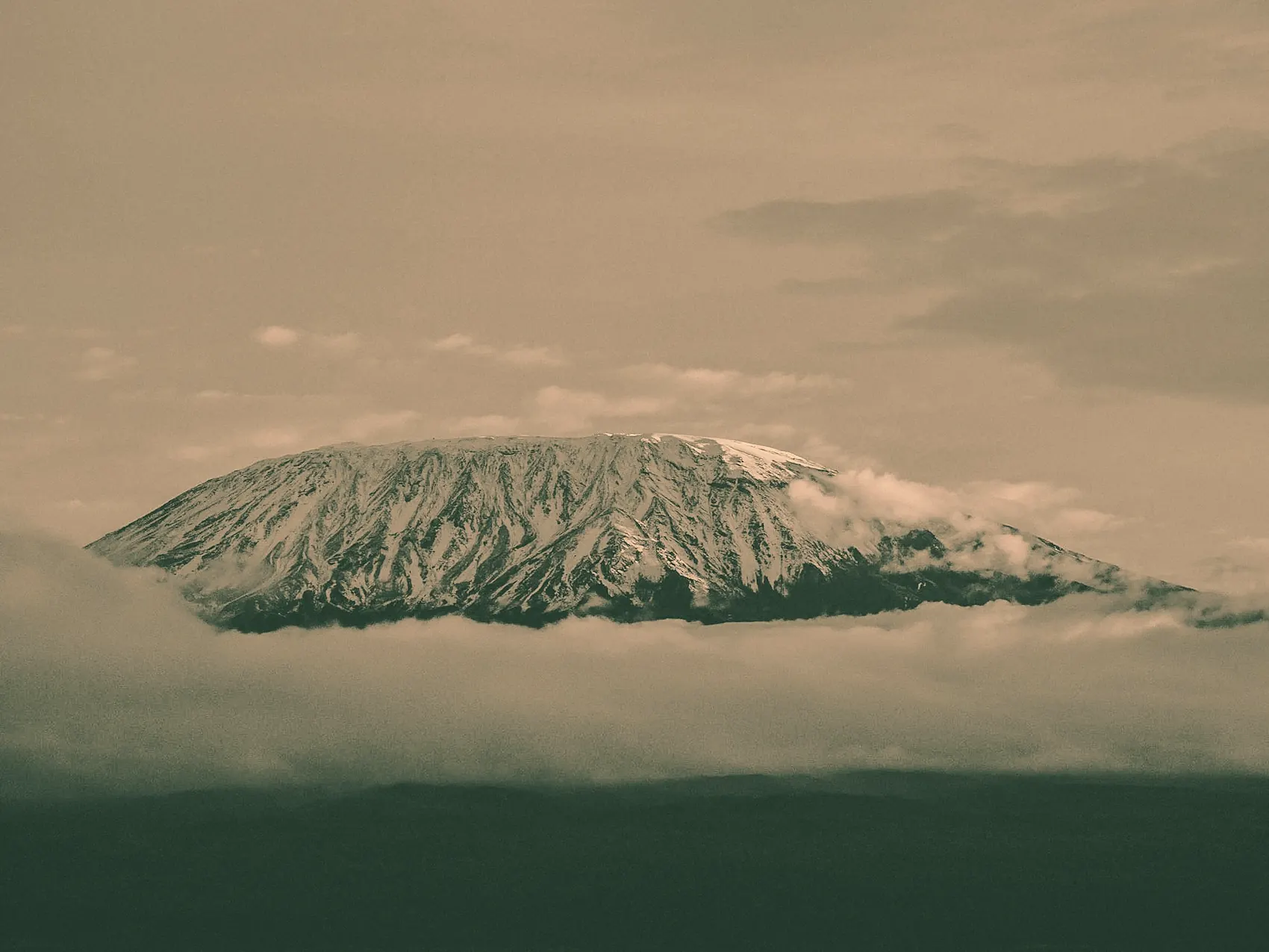 The snow-capped summit of Kilimanjaro above a sea of cloud